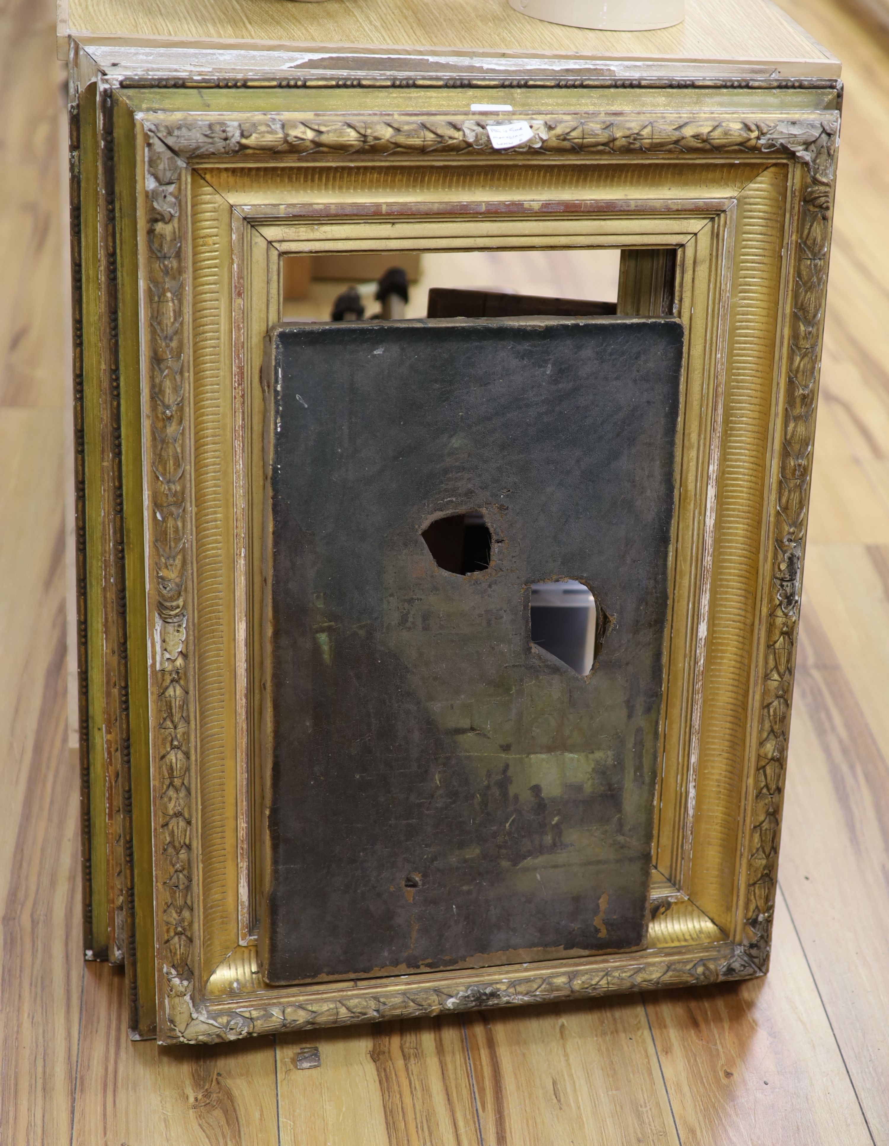 19th century Continental School, oil on canvas, Napoleonic soldiers in a courtyard, monogrammed, 54 x 32cm, holed and torn, with a pair of original gilt gesso frames now in tatty order and an additional stretcher